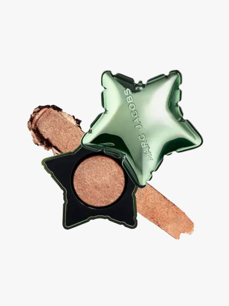 Green star-shaped container of Marc Jacobs Beauty Born Star Eyeshadow on light gray background